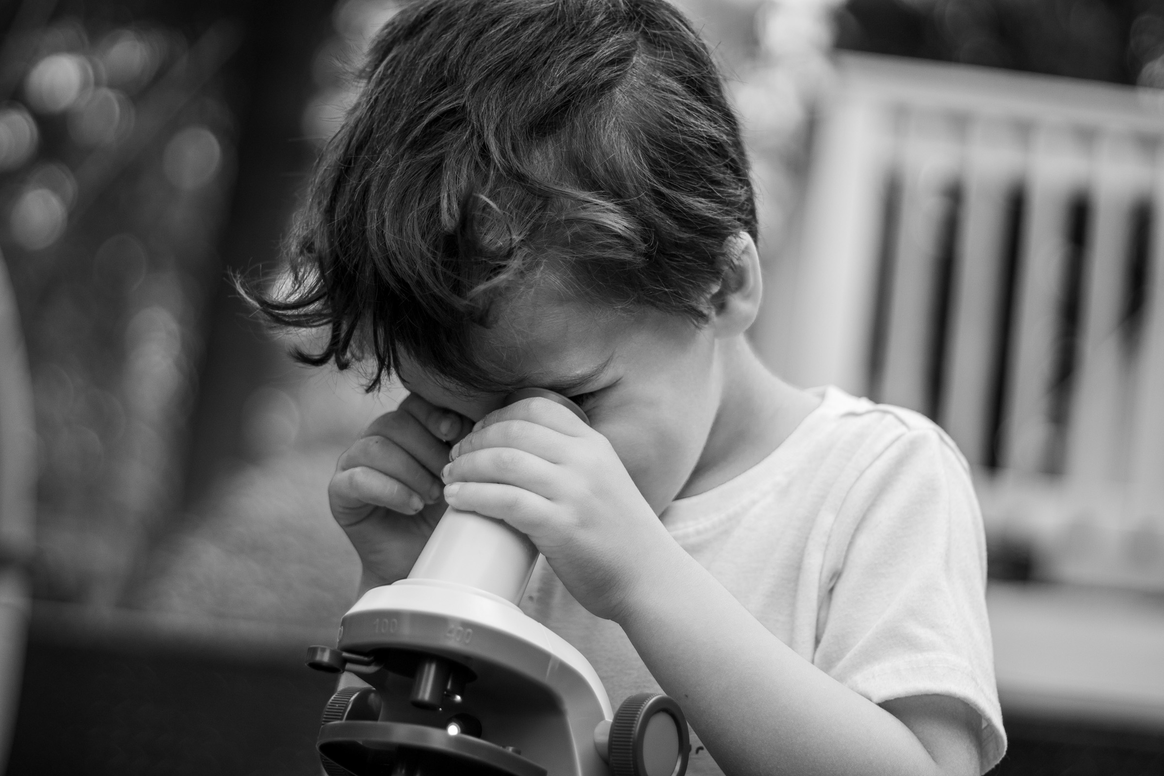 He looks through a microscope